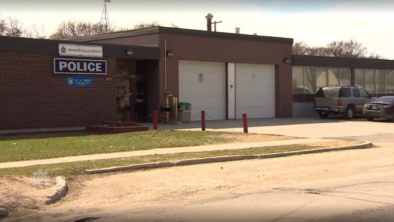 The exterior of a one-storey brick building with a large sign reading 'Police.'