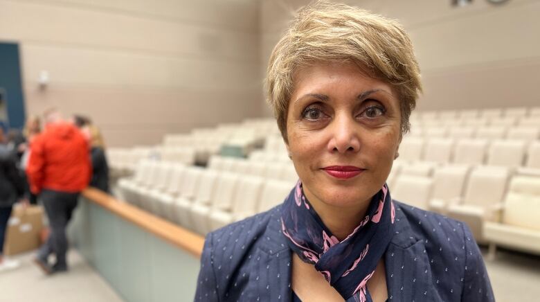 A close-up shot of a woman with short cropped hair.