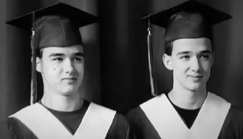 Two similarly looking boys in graduation cap and gown.