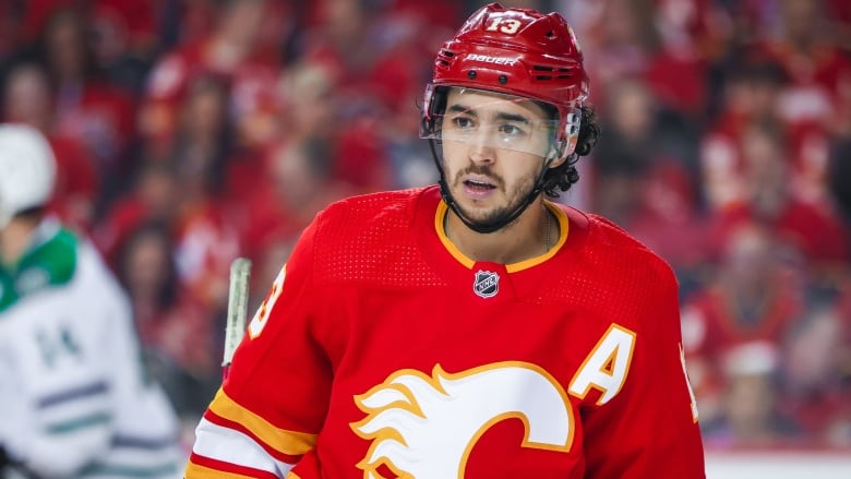 A man in a Calgary Flames hockey team uniform.