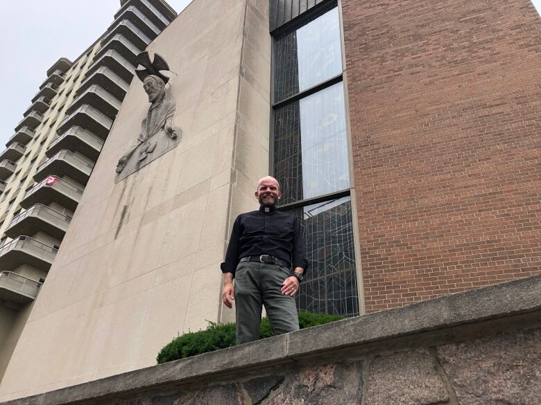 Pastor Mark Ehlebracht stands in front of St. Peter's Lutheran Church where 41 affordable housing units will be built.