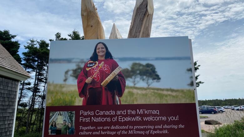 A P.E.I. National Park sign featuring Julie Pellissier-Lush, P.E.I.'s first Indigenous poet laureate, welcomes people to Brackley Beach. 