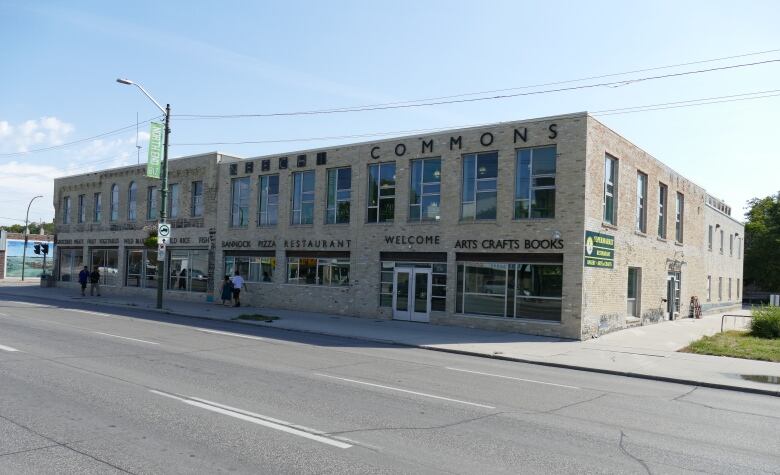 The exterior of brick building with a large sign reading 