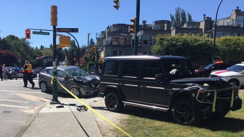 A car with visible front damage is behind an SUV with similar damage.