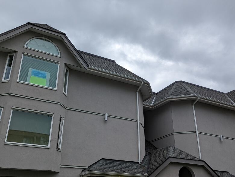 The roof of a single-family home, which is grey in colour.