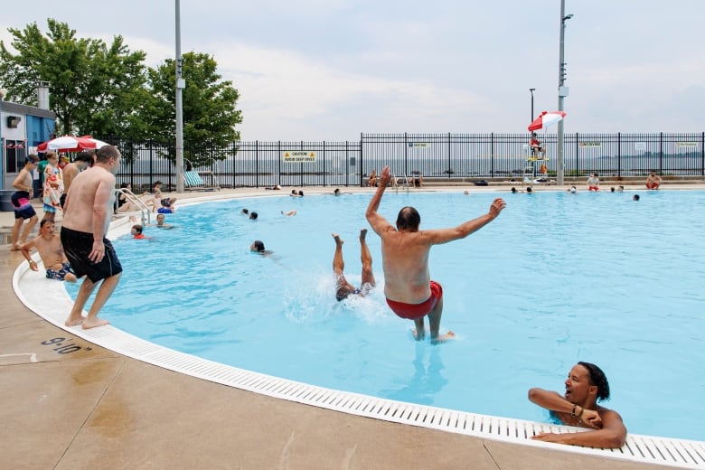 Man jumps into pool.