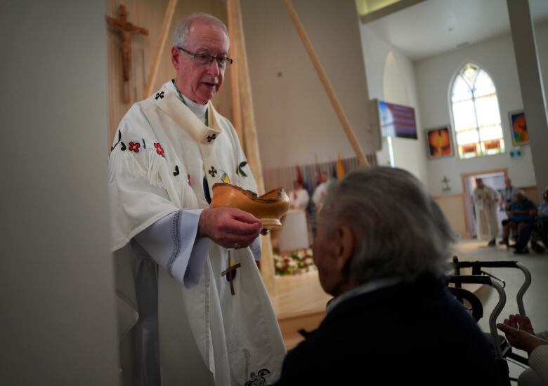 A man holds a bowl.