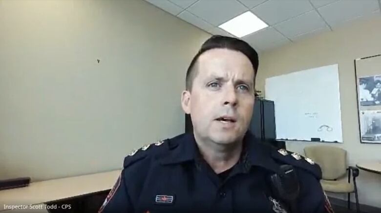 A man in uniform speaks in a video conference.