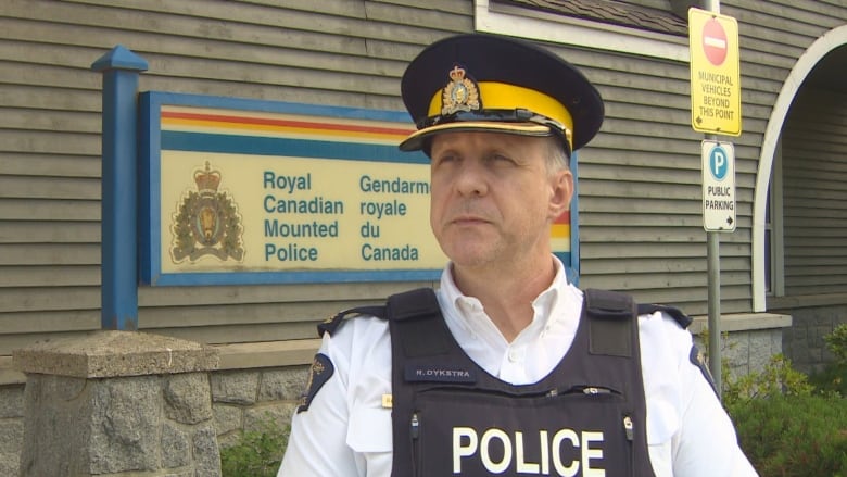 RCMP Inspector Robert Dykstra stands in front the Whistler RCMP detachment wearing his police uniform. Dykstra says two people were arrested in Squamish in connection with the shooting deaths of two men in the Whistler village on Sunday.