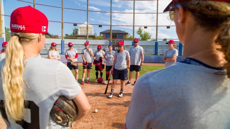 Members of Canada's national women's baseball team gather during a practice on Wednesday morning in Thunder Bay, Ont., ahead of a five-game friendly series with Team U.S.A.