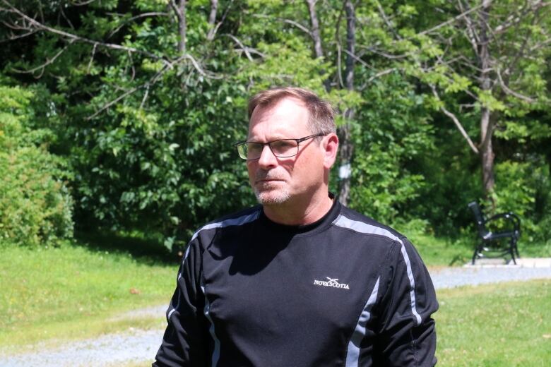 Man wearing rectangular glasses and a black shirt near Harry DeWolf Park in Bedford.