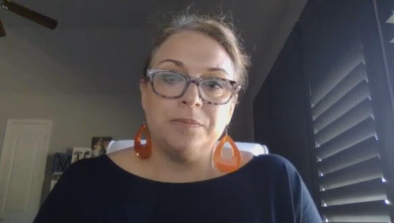 A closeup of a woman in a home office.