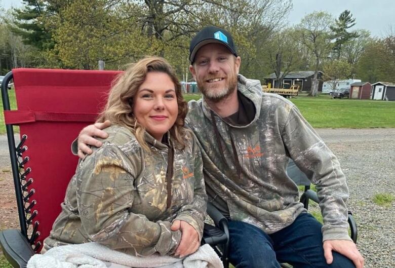 A man and a woman sit next to each other.