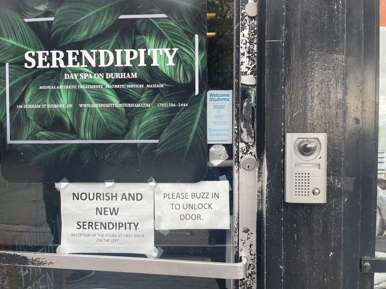 A shiny metal locking system is next to the door of Serendipity Spa.