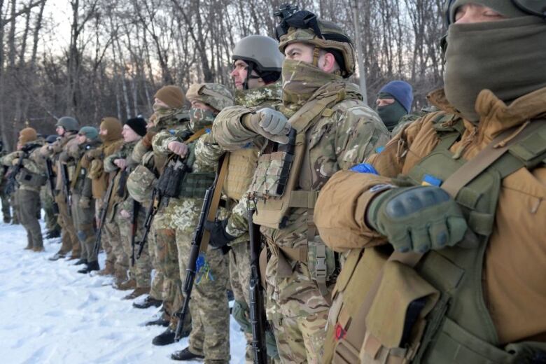 Soldiers stand in a row.