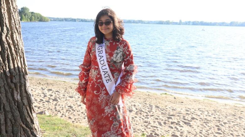 A girl wearing a sash with the word 