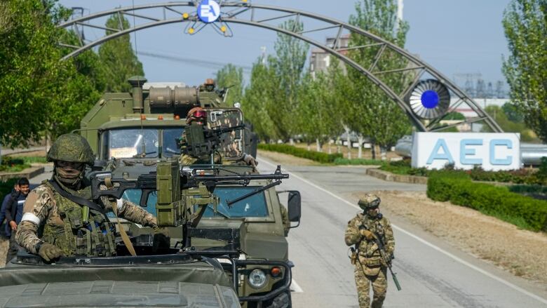 Soldiers walk near nuclear plant.