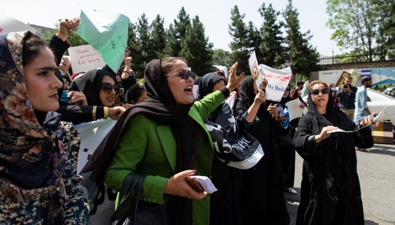 Women demonstrate ahead of the first anniversary of the Taliban's return to power in Kabul on Saturday.