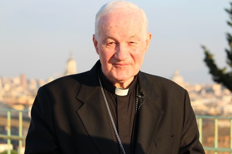 Picture of a priest dressed in black.