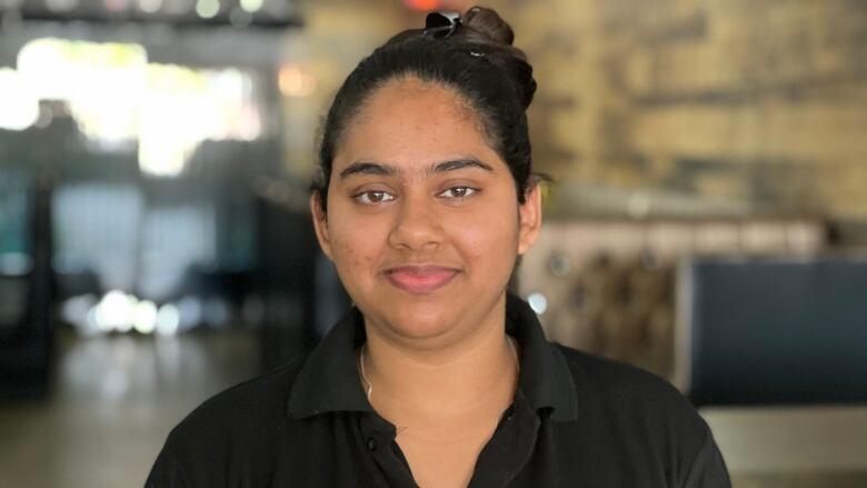 An Indian woman standing in a restaurant.