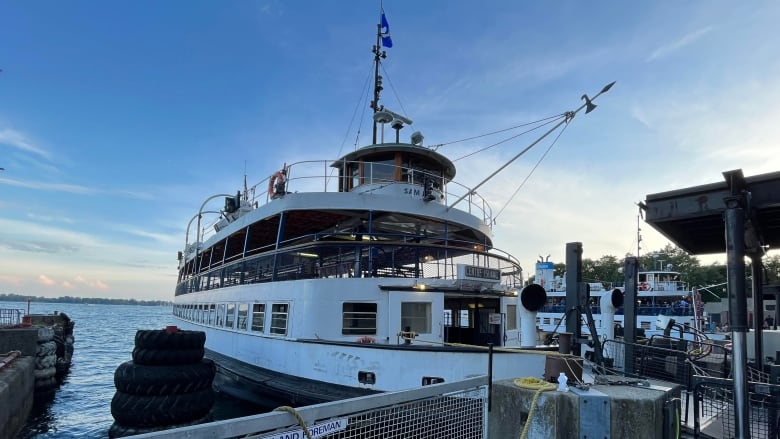 a white ferry is pictured docked