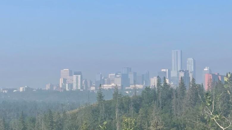 Smoke appears over the skyline of downtown Edmonton. 