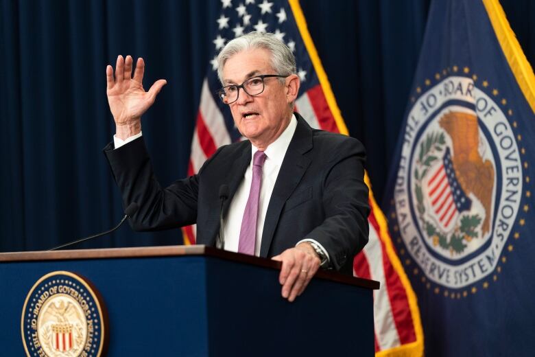 A man speaks at a government podium.