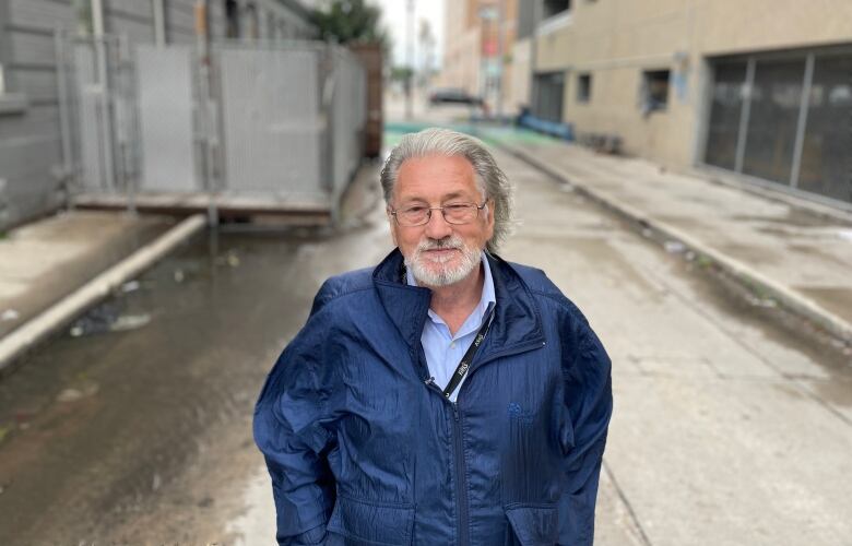 A man stands on a road.