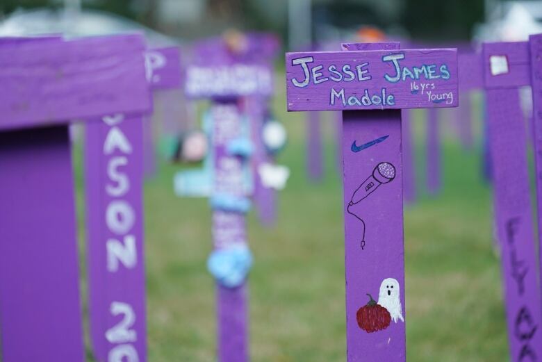 A wooden, purple marker reads: Jesse James Madole 16 years young. 