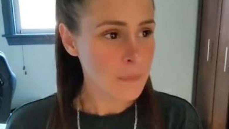 A woman looks pensively in a still taken from a TikTok video.