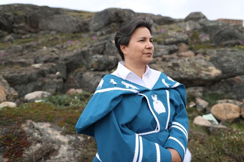 A woman wearing a blue traditional Inuit amauti 