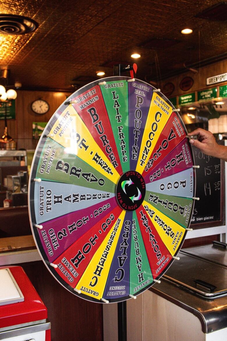 A spin the wheel advertises free snacks like burgers. 