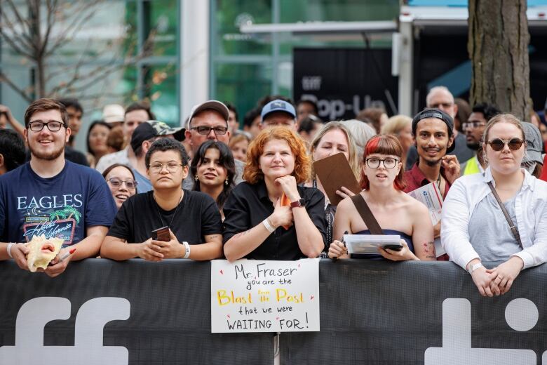 Fans reach for autographs as Brendan Fraser walks the red carpet before the TIFF premier of The Whale on Sept. 1, 2022.