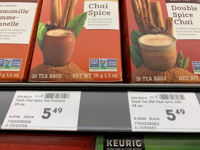 Two boxes of chai tea on a grocery store shelf, with different price tags in front of them. 