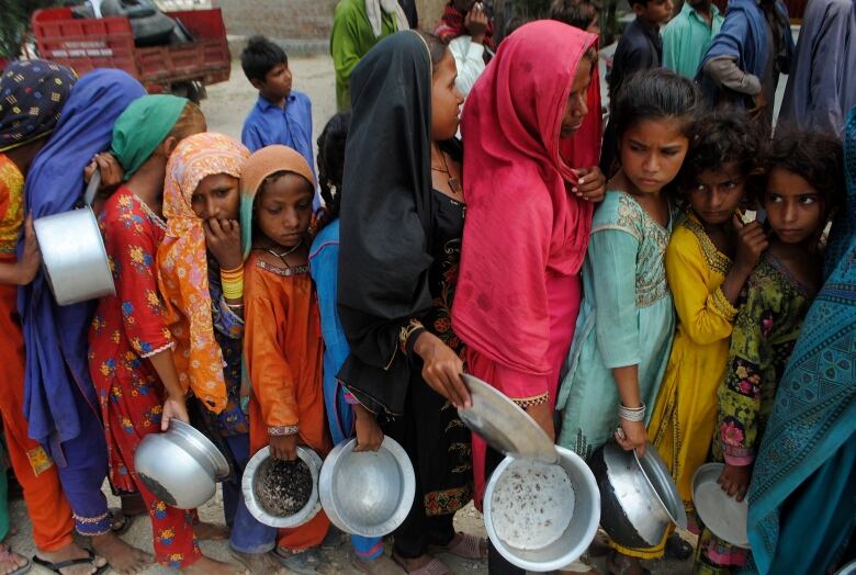 Women wait in line for food.