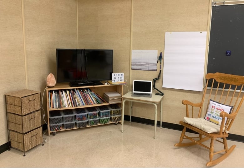 A wooden rocking chair in a classroom.