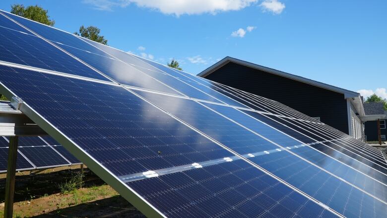 solar panel in a yard beside a home