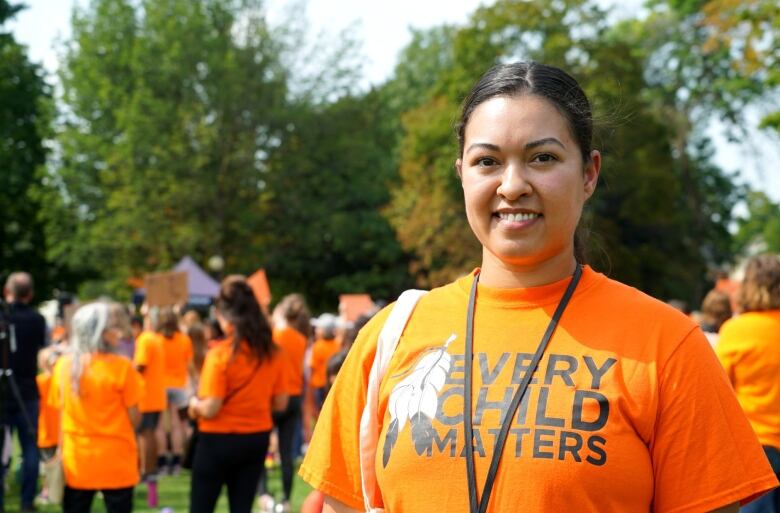 A woman wearing an orange Every Child Matters shirt.