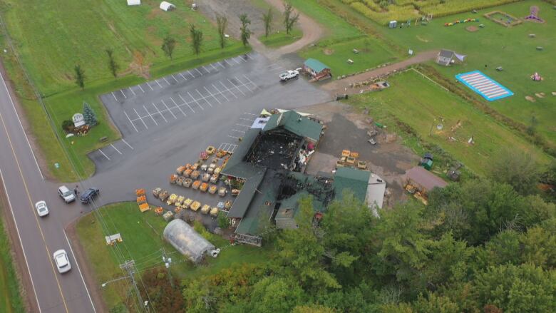 Arial shot of a building with collapsed roof, showing charred insides.