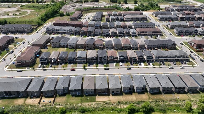 Rows of new houses can be seen. 