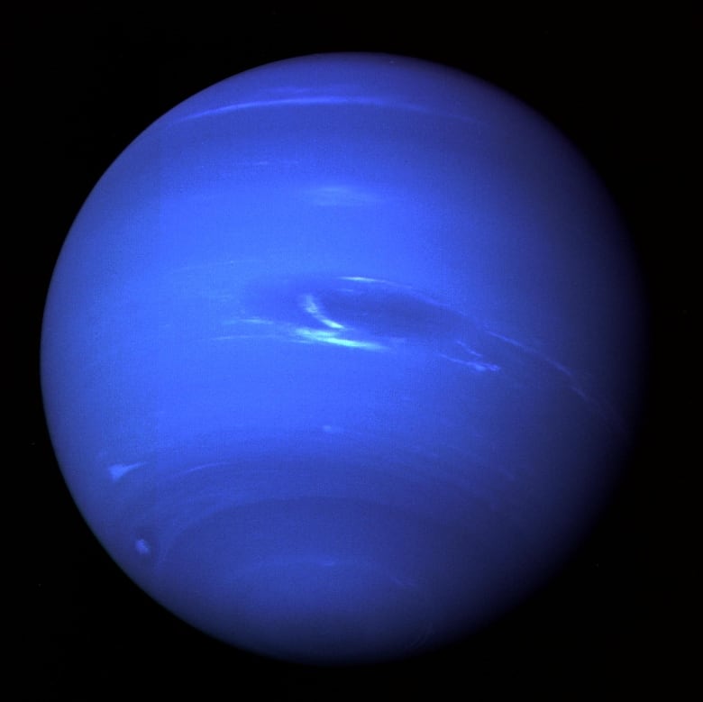 A blue planet against a black background with some light blue swirls wrapping around the center.