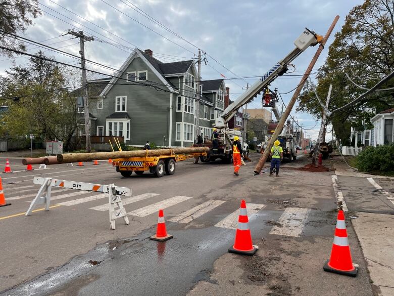 street blocked off with pylons as power crews replace a power pole in Charlottetown