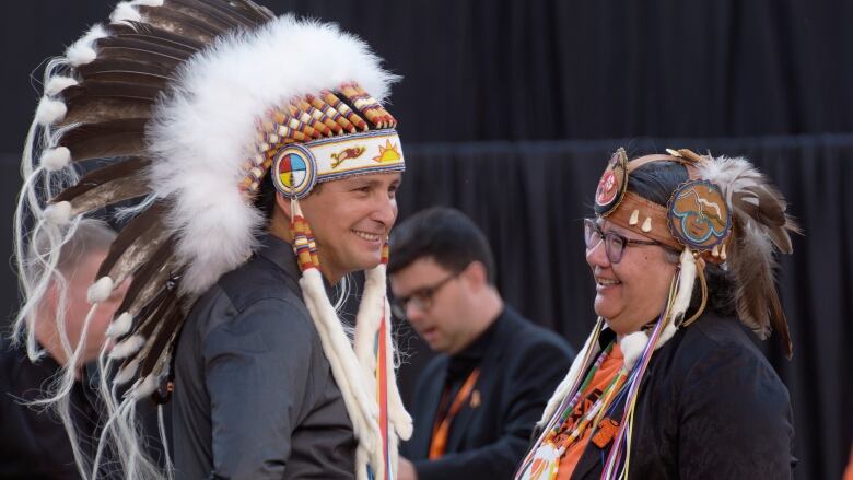 Cowessess First Nation Chief Cadmus Delorme, left, speaks with AFN National Chief RoseAnne Archibald back stage at Miyo-wiciwitowin Day held at at Mosaic Stadium in Regina, Thursday, Sept. 29, 2022. The event gathered 18,000 high school students, business leaders and the public to discuss the impact of residential schools and the importance of implementing the 94 calls to action set out by the Truth and Reconciliation Commission. 