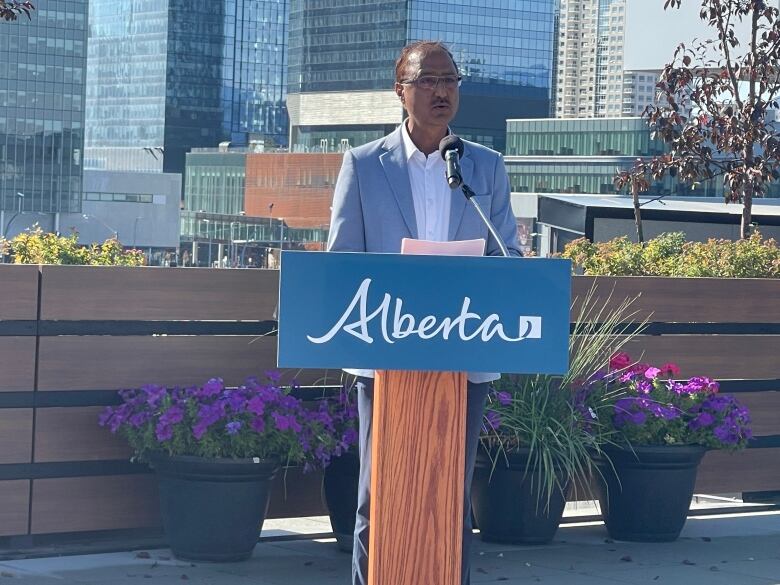 A man stands at a podium with 