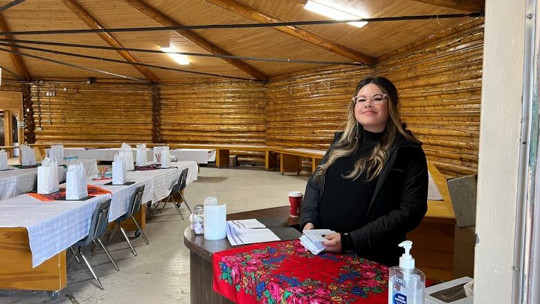 Smiling woman in an NWT community hall. 