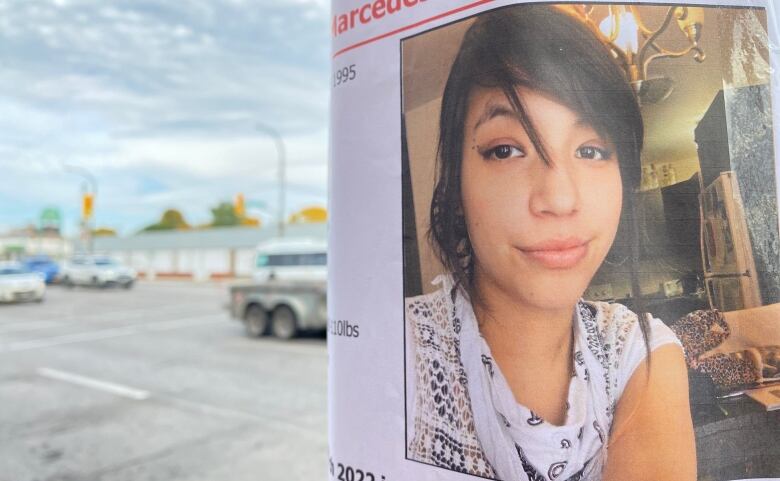 An image of a woman on a missing poster is pictured.