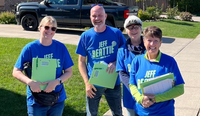 Four people wearing blue 