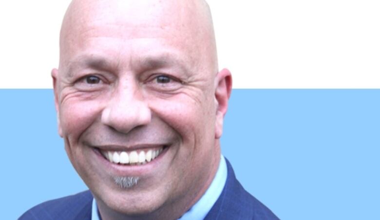 Close up headshot of a guy smiling.