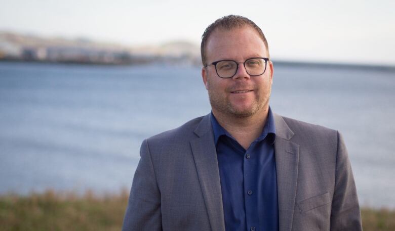 A man outside in front of a bay.