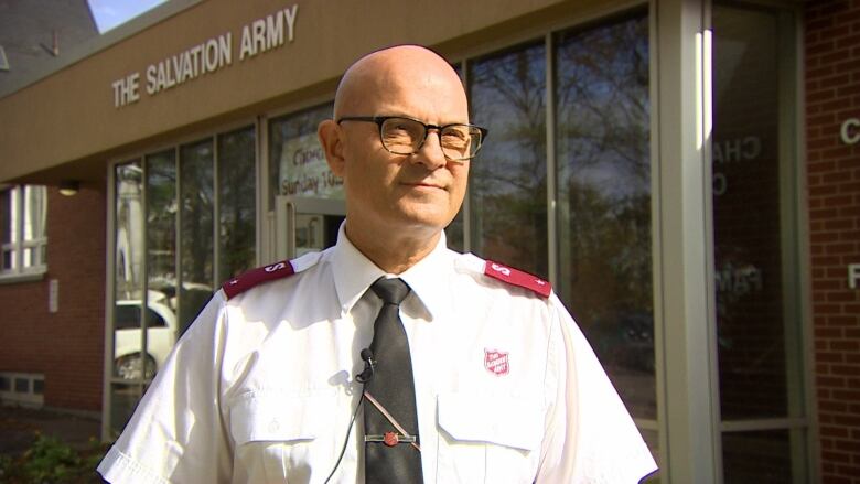 A man in a Salvation Army uniform stands outside the Salvation Army Building in Charlottetown, P.E.I. 